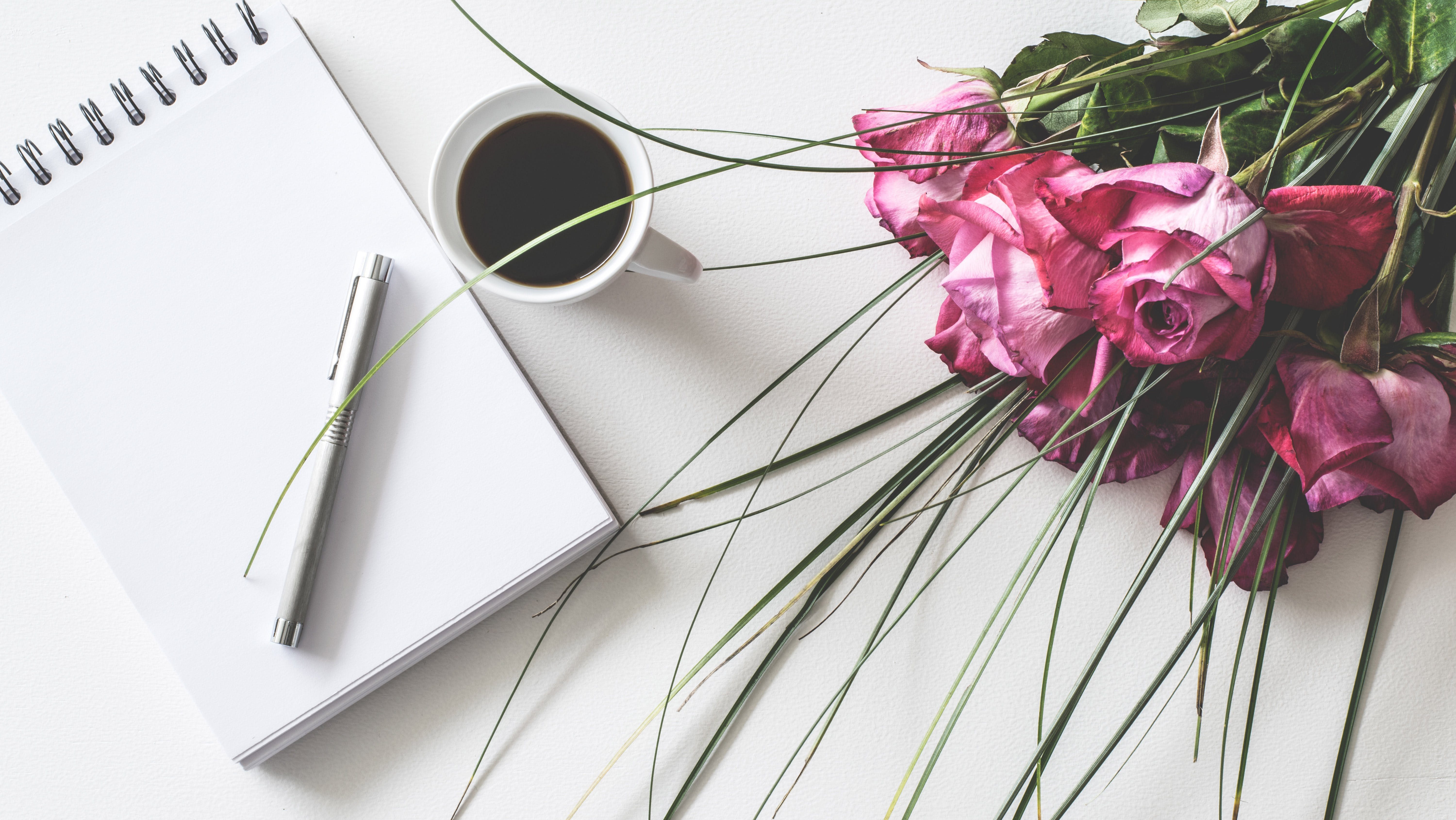 Photo by Lum3n: https://www.pexels.com/photo/red-rose-flowers-bouquet-on-white-surface-beside-spring-book-with-click-pen-and-cup-of-cofffee-1410226/